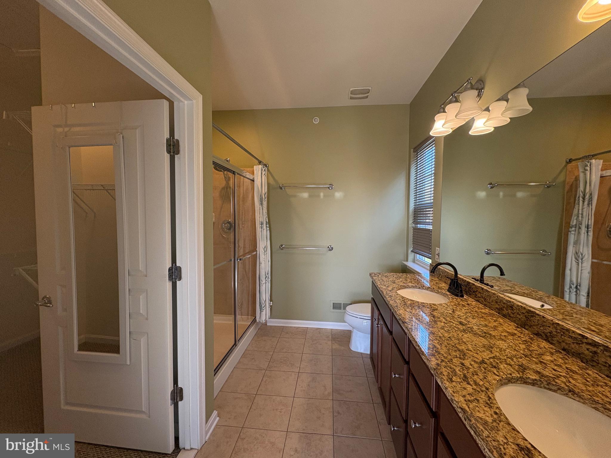 580 Prizer Court Downingtown, PA 19335 - Photo 11 of 28 a bathroom with a granite countertop double vanity sink a mirror and a shower