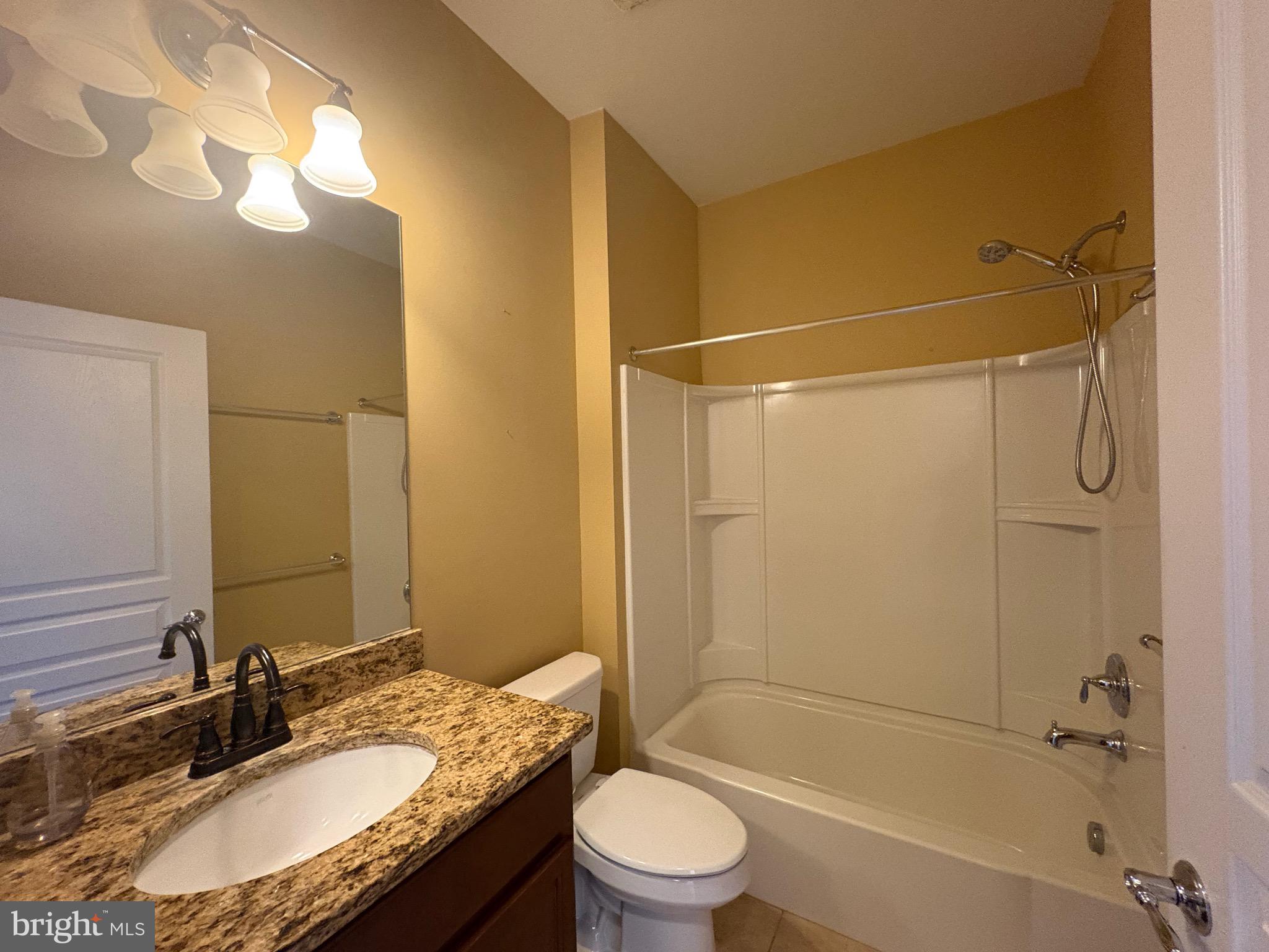 580 Prizer Court Downingtown, PA 19335 - Photo 16 of 28 a bathroom with a granite countertop sink toilet mirror and shower
