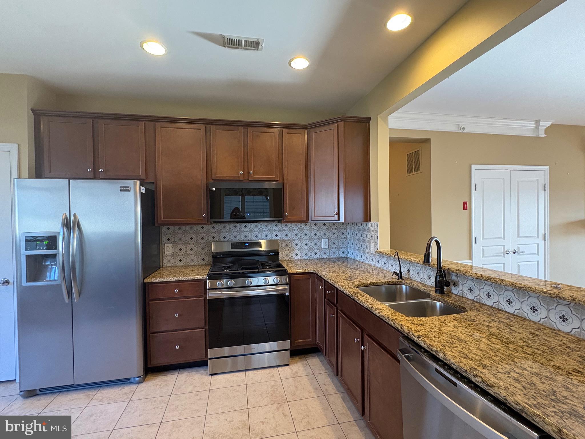 580 Prizer Court Downingtown, PA 19335 - Photo 4 of 28 a kitchen with stainless steel appliances granite countertop a sink counter space cabinets and stainless steel appliances