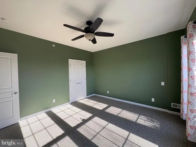 a bedroom with a bed and a ceiling fan