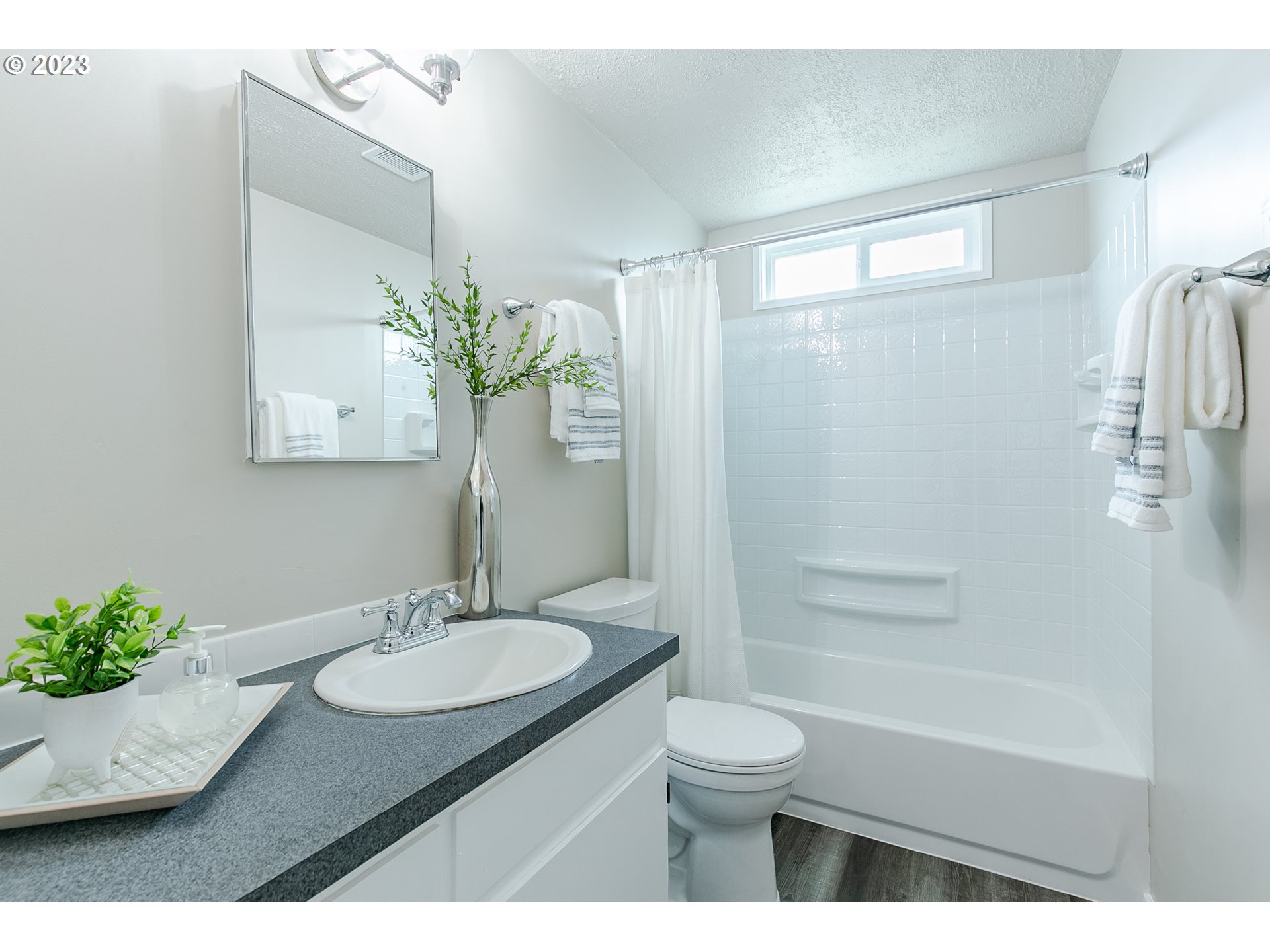 594 39th Street Springfield, OR 97478 - Photo 14 of 18 a bathroom with a granite countertop sink a toilet a mirror and shower