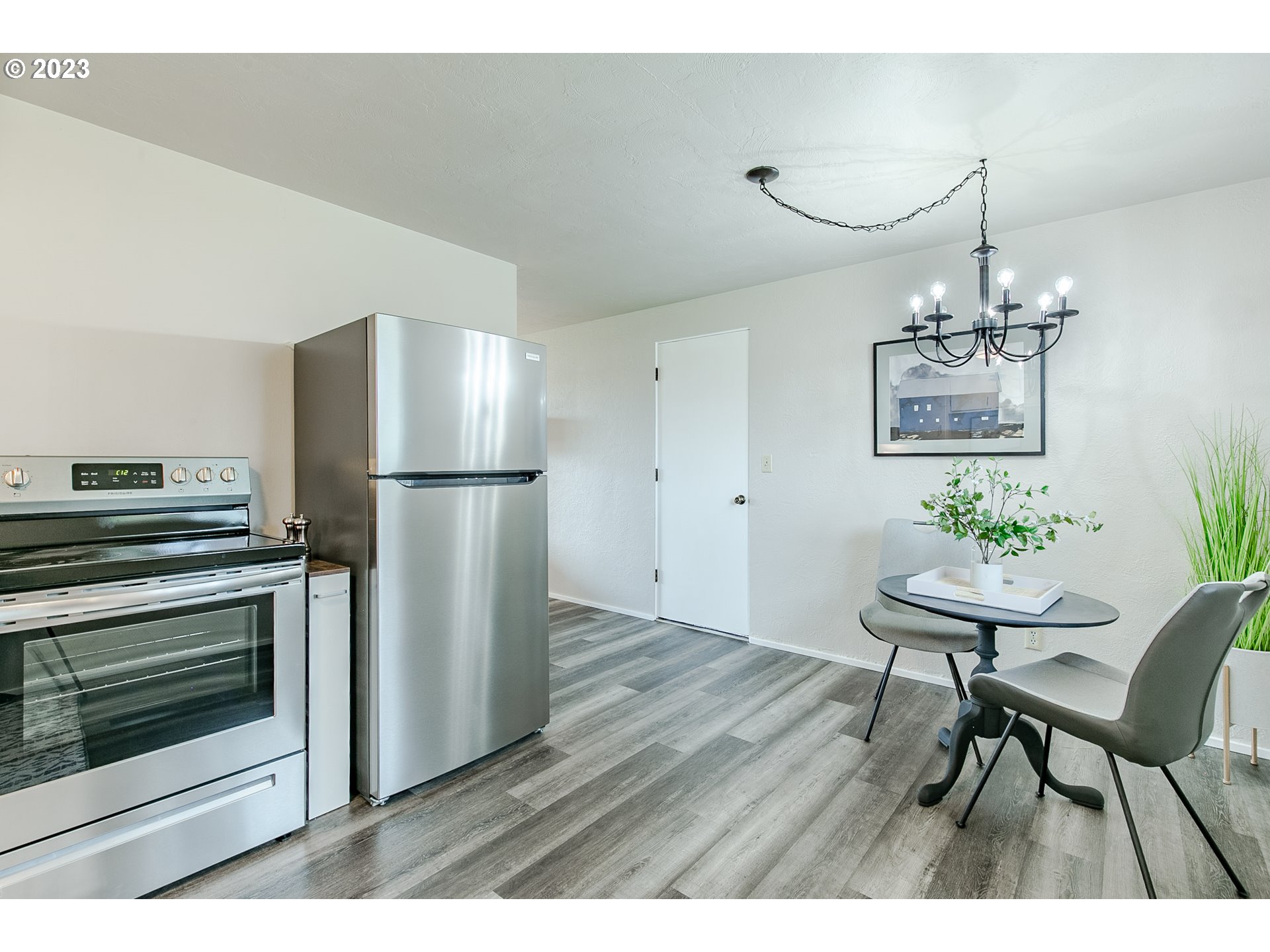 594 39th Street Springfield, OR 97478 - Photo 10 of 18 a kitchen with stainless steel appliances refrigerator dining table and chairs