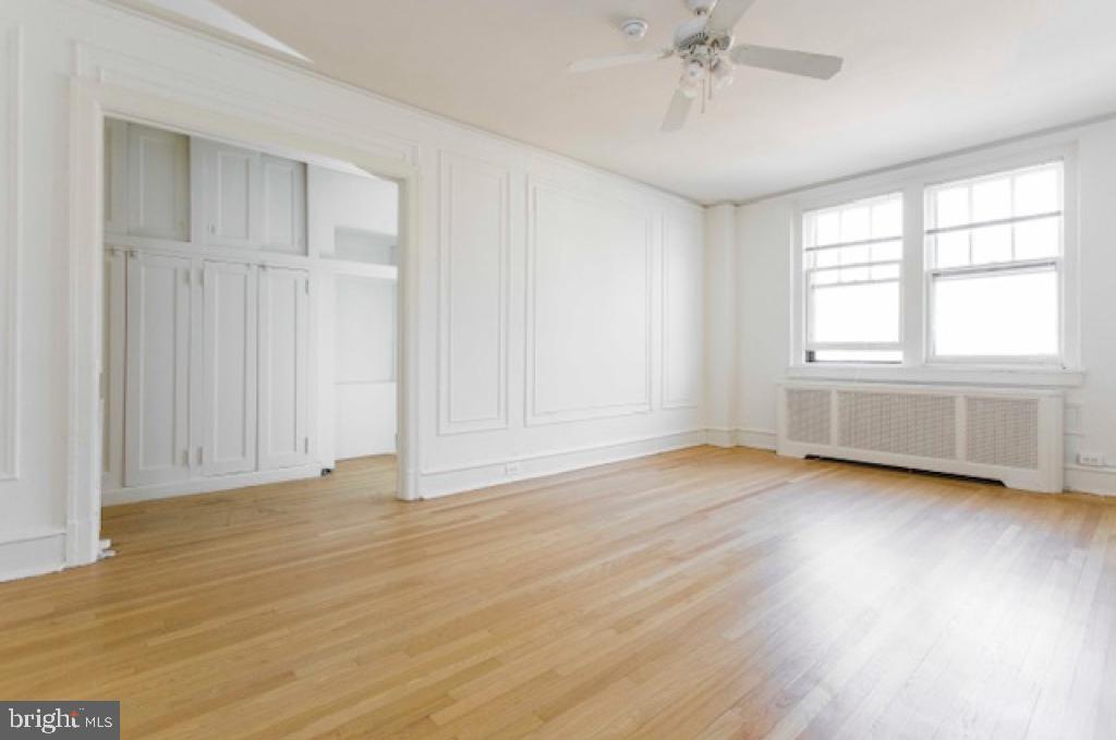 2100-2 Walnut Street, Unit 12K Philadelphia, PA 19103 - Photo 21 of 34 an empty room with wooden floor and windows