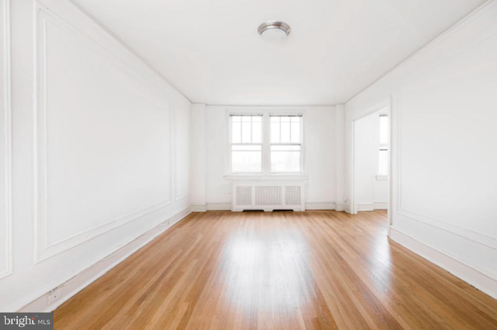 2100-2 Walnut Street, Unit 12K Philadelphia, PA 19103 - Photo 23 of 34 an empty room with wooden floor and windows