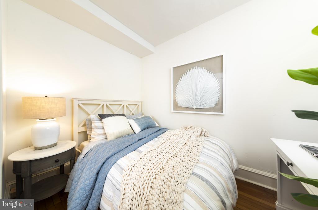 2100-2 Walnut Street, Unit 12K Philadelphia, PA 19103 - Photo 7 of 34 a bedroom with a bed and a chair
