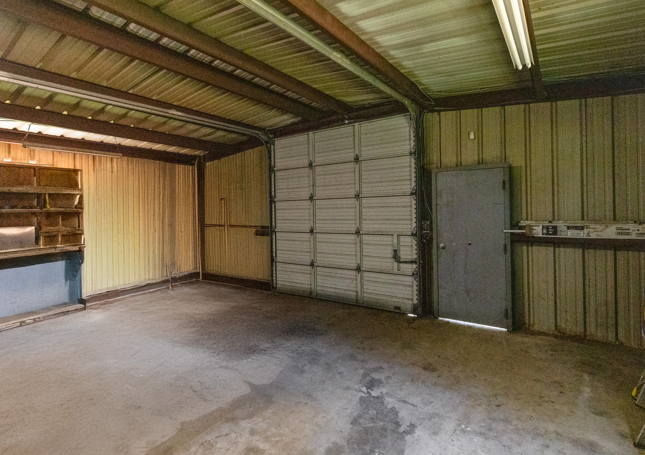 14818 Walker Road Conroe, TX 77302 - Photo 44 of 44 Shop- Roll-Up Door and Shelves