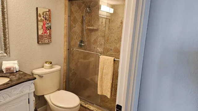 a white toilet sitting next to a bathroom sink