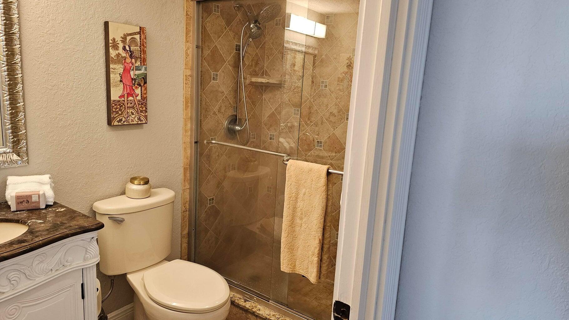 4511 South Ocean Boulevard, Unit 807 Highland Beach, FL 33487 - Photo 13 of 21 a white toilet sitting next to a bathroom sink