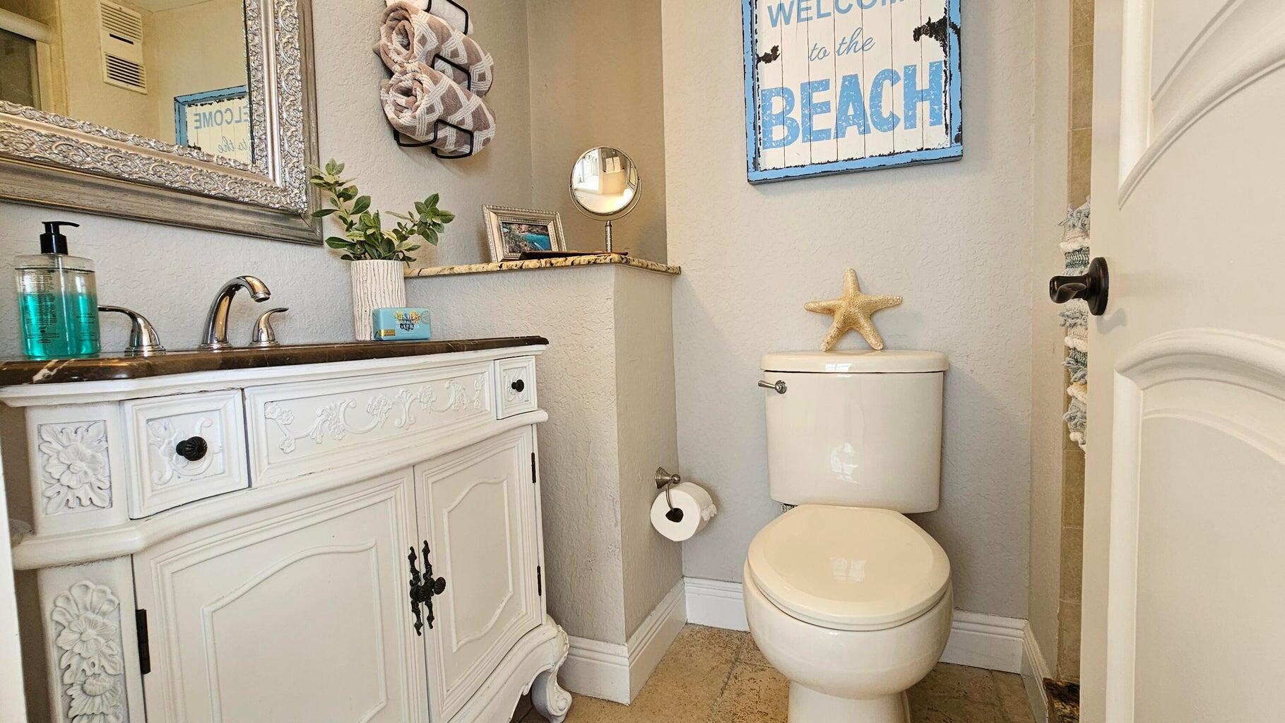 4511 South Ocean Boulevard, Unit 807 Highland Beach, FL 33487 - Photo 14 of 21 a bathroom with a toilet sink and mirror