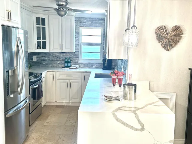 a kitchen with a sink appliances and cabinets