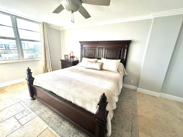 a large bed sitting in a bedroom next to a window