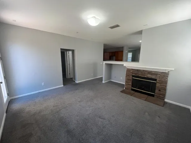 a view of empty room with a fireplace