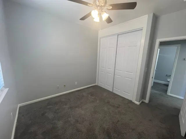 an empty room with a fan and a fan