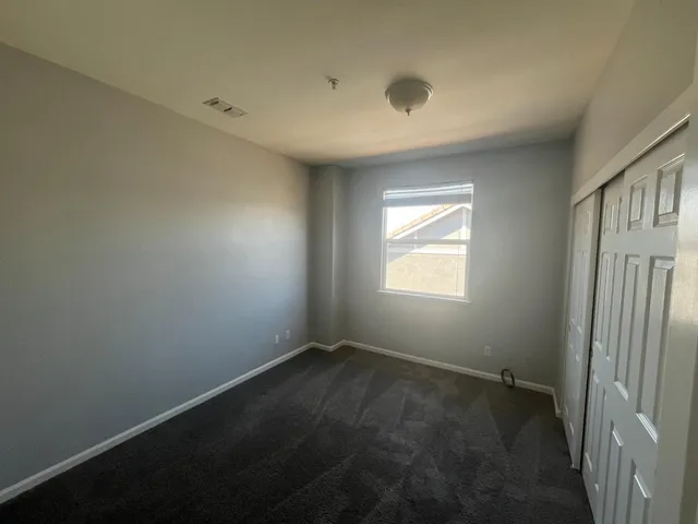 an empty room with a empty space and windows
