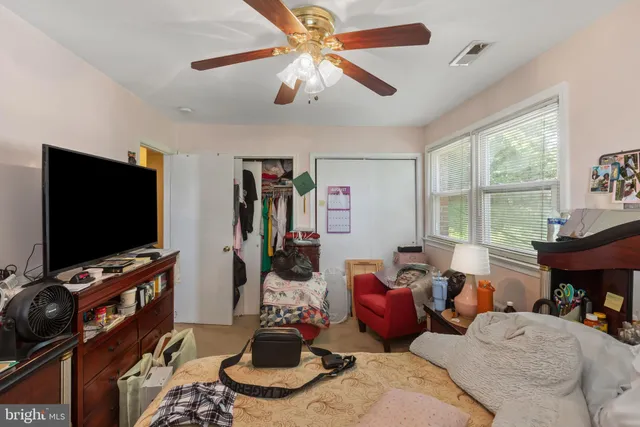 a bedroom with bed and a window