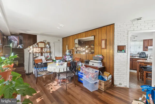 a room with lots of furniture and wooden floor