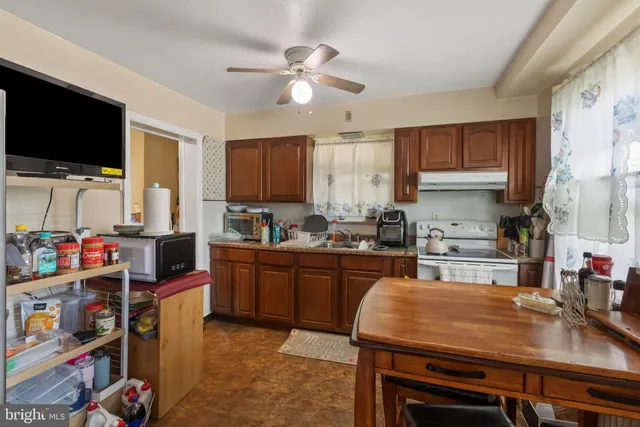 a kitchen with a stove a sink and a refrigerator