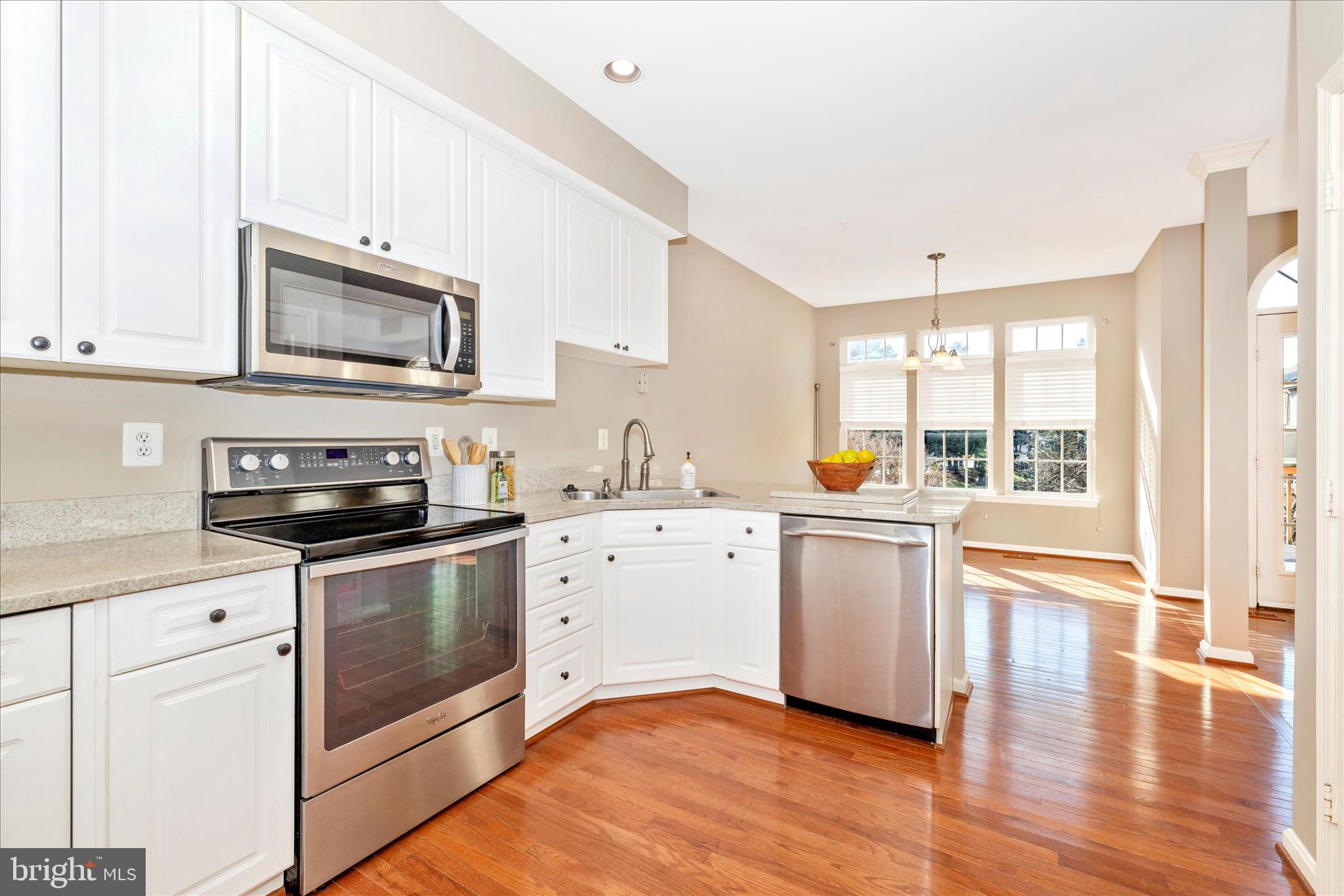 2409 Rippling Brook Road Frederick, MD 21701 - Photo 13 of 69 a kitchen with granite countertop cabinets stainless steel appliances and wooden floor