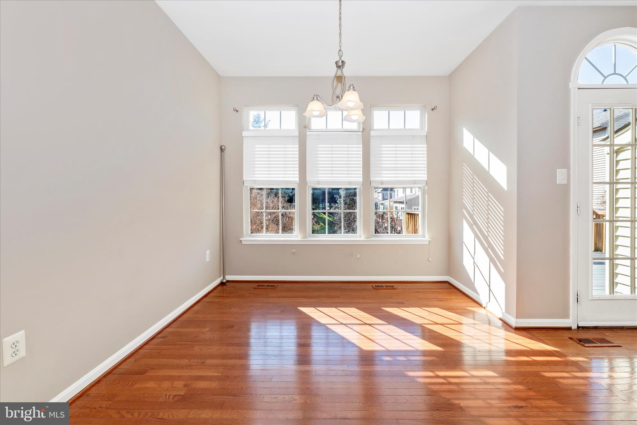 2409 Rippling Brook Road Frederick, MD 21701 - Photo 18 of 69 a view of an empty room with wooden floor and a window