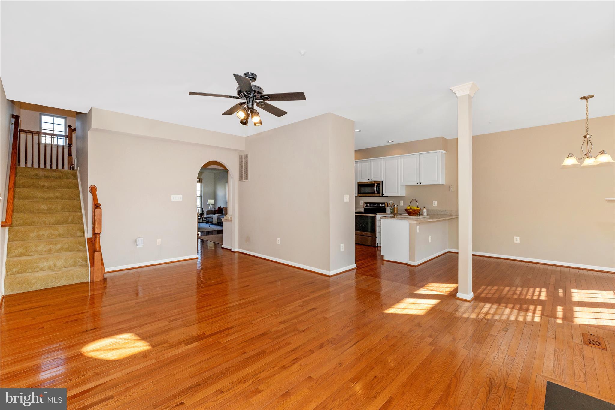 2409 Rippling Brook Road Frederick, MD 21701 - Photo 21 of 69 a view of a kitchen with wooden floor and a ceiling fan