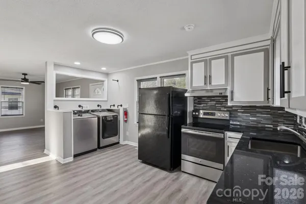 a kitchen with a refrigerator stove and wooden cabinets