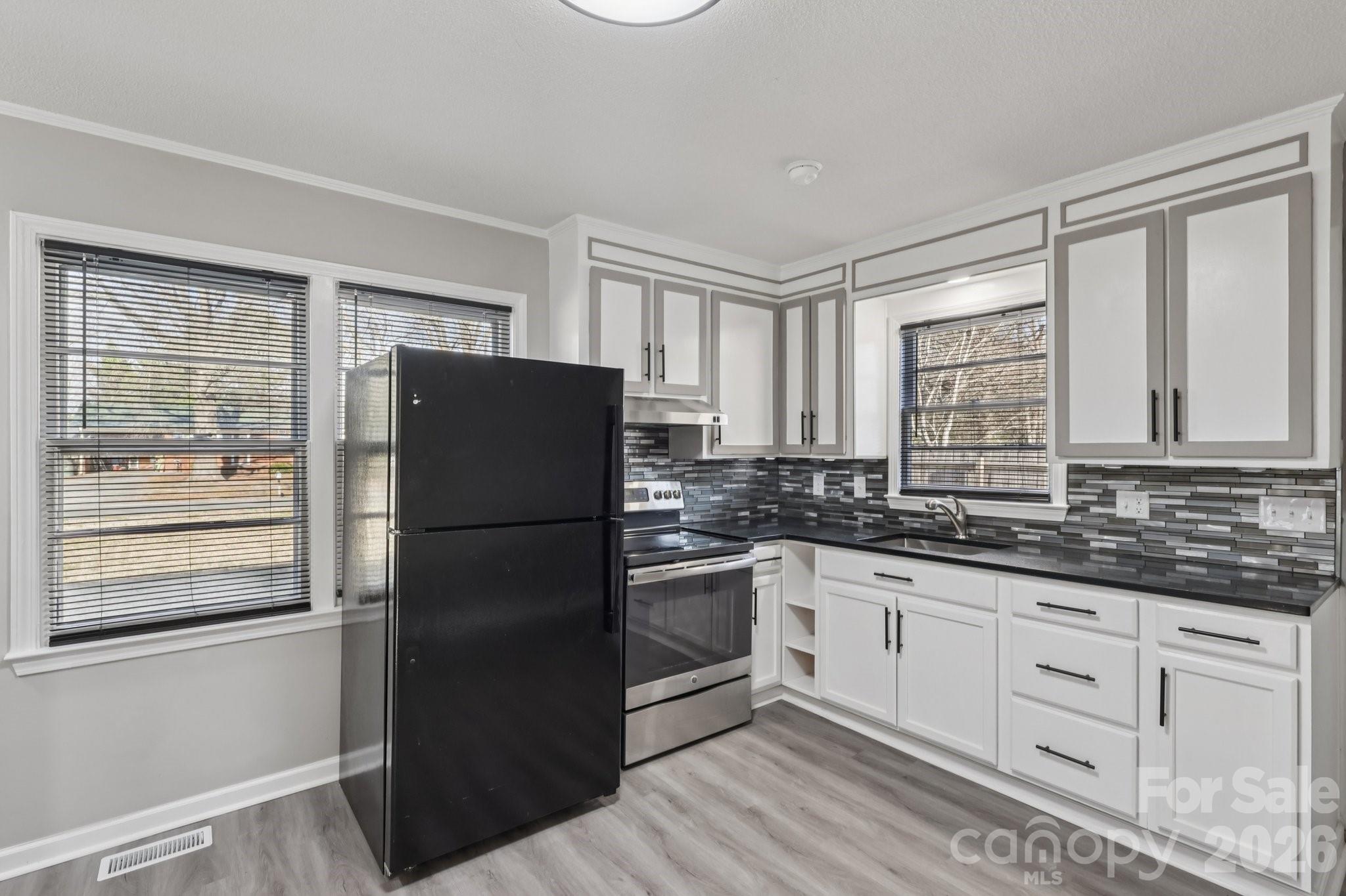 3207 Valley Dale Road Monroe, NC 28110 - Photo 13 of 30 a kitchen with granite countertop stainless steel appliances a refrigerator sink and cabinets