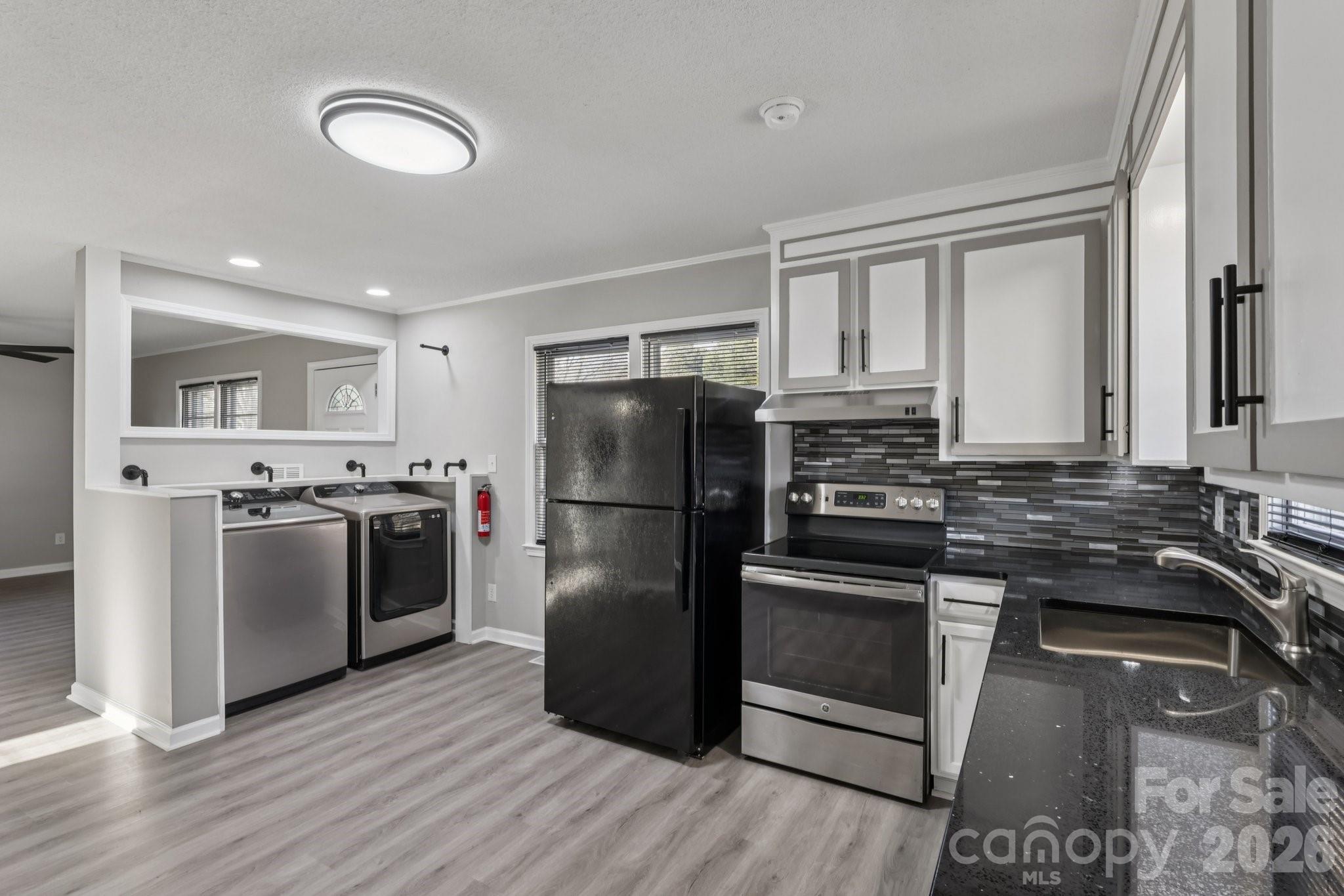 3207 Valley Dale Road Monroe, NC 28110 - Photo 14 of 30 a kitchen with a refrigerator and a stove top oven