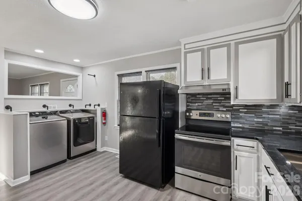 a kitchen with a refrigerator sink and stove top oven
