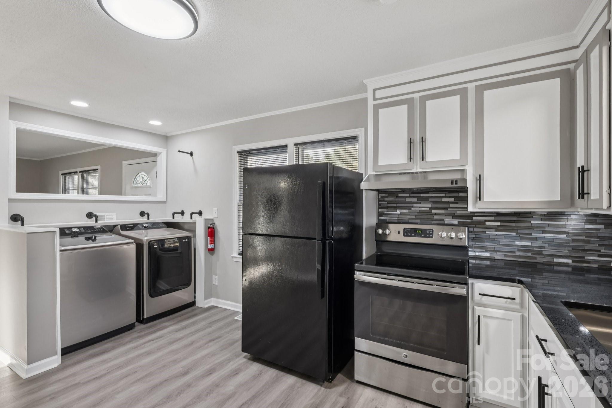 3207 Valley Dale Road Monroe, NC 28110 - Photo 15 of 30 a kitchen with a refrigerator sink and stove top oven