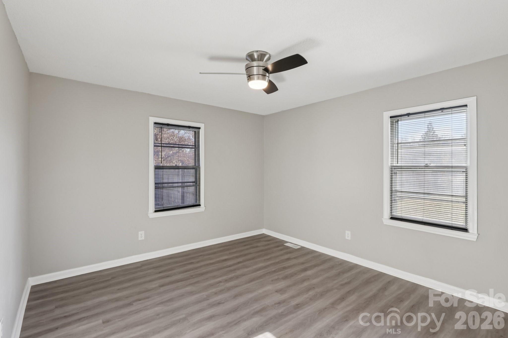3207 Valley Dale Road Monroe, NC 28110 - Photo 16 of 30 a view of an empty room with a window and wooden floor