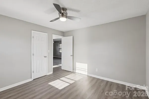 a view of an empty room with wooden floor