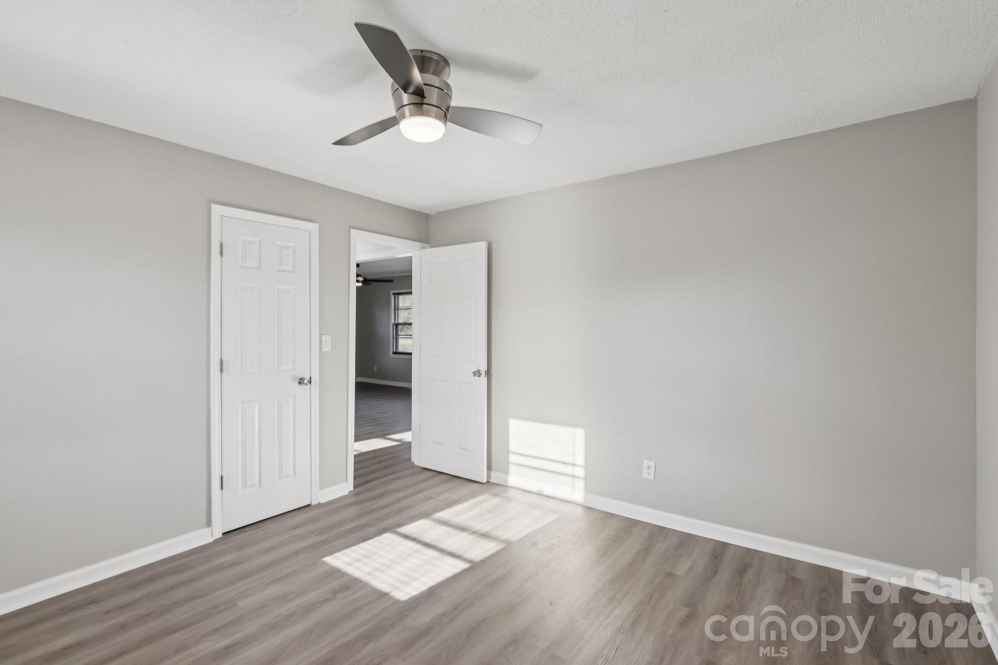 3207 Valley Dale Road Monroe, NC 28110 - Photo 18 of 30 a view of an empty room with wooden floor