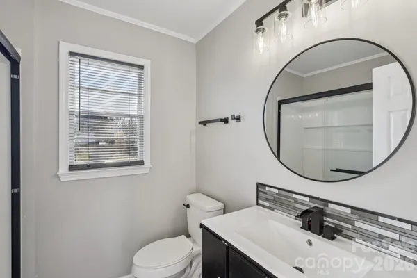 a bathroom with a sink a mirror and a toilet