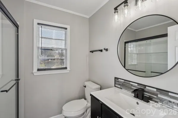 a bathroom with a sink a mirror and a toilet