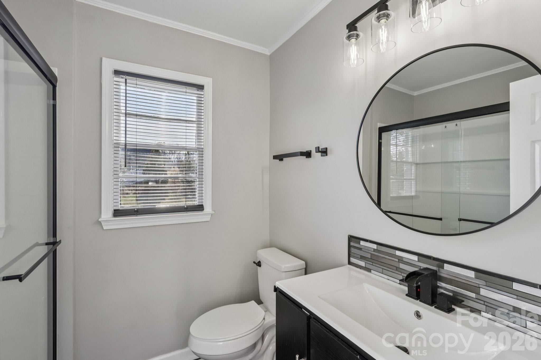 3207 Valley Dale Road Monroe, NC 28110 - Photo 20 of 30 a bathroom with a sink a mirror and a toilet