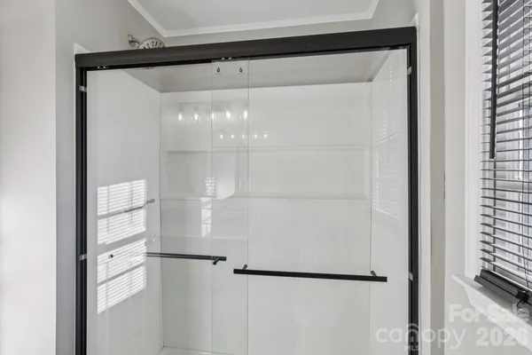 a bathroom with a glass shower door