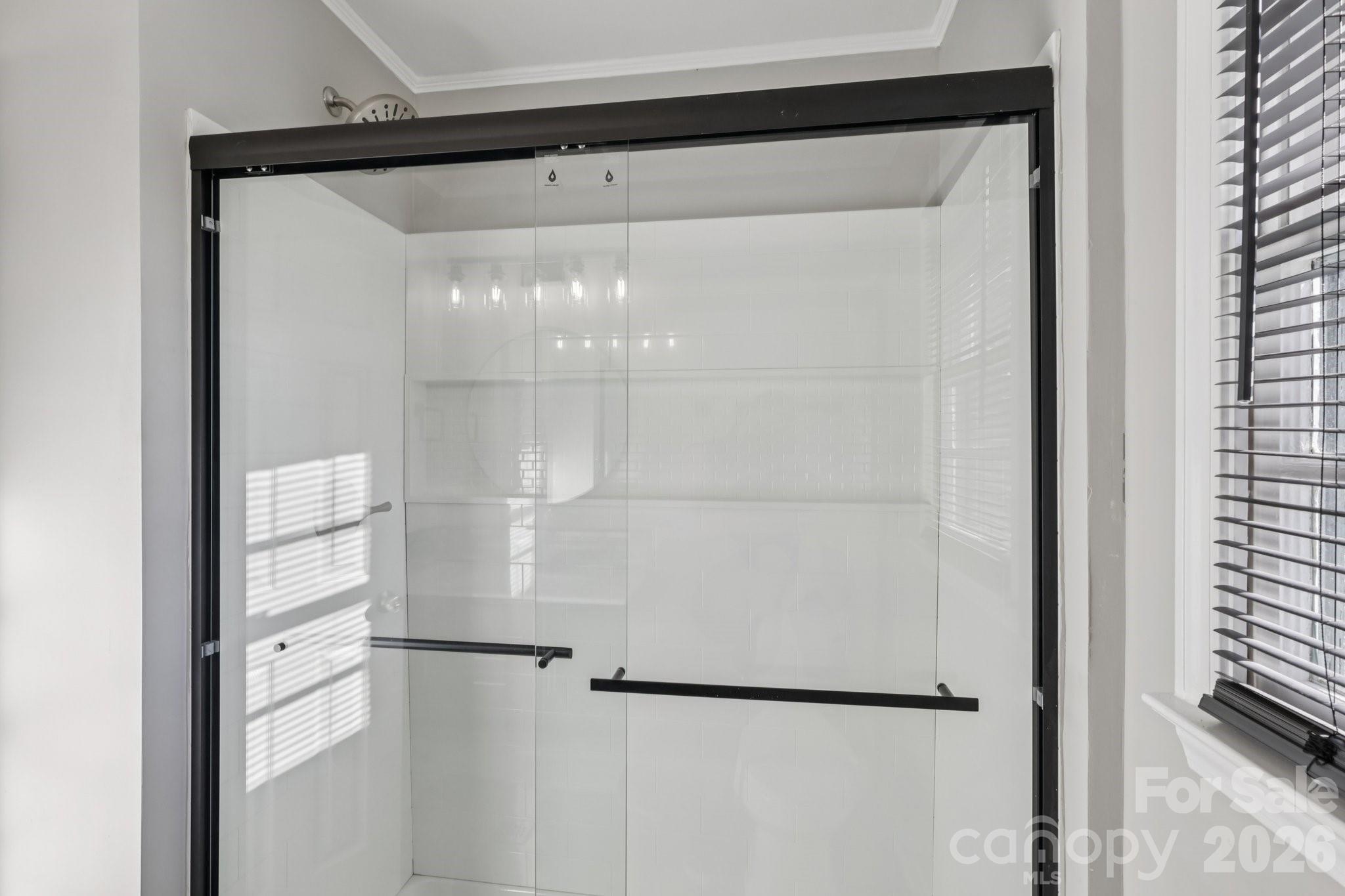 3207 Valley Dale Road Monroe, NC 28110 - Photo 21 of 30 a bathroom with a glass shower door