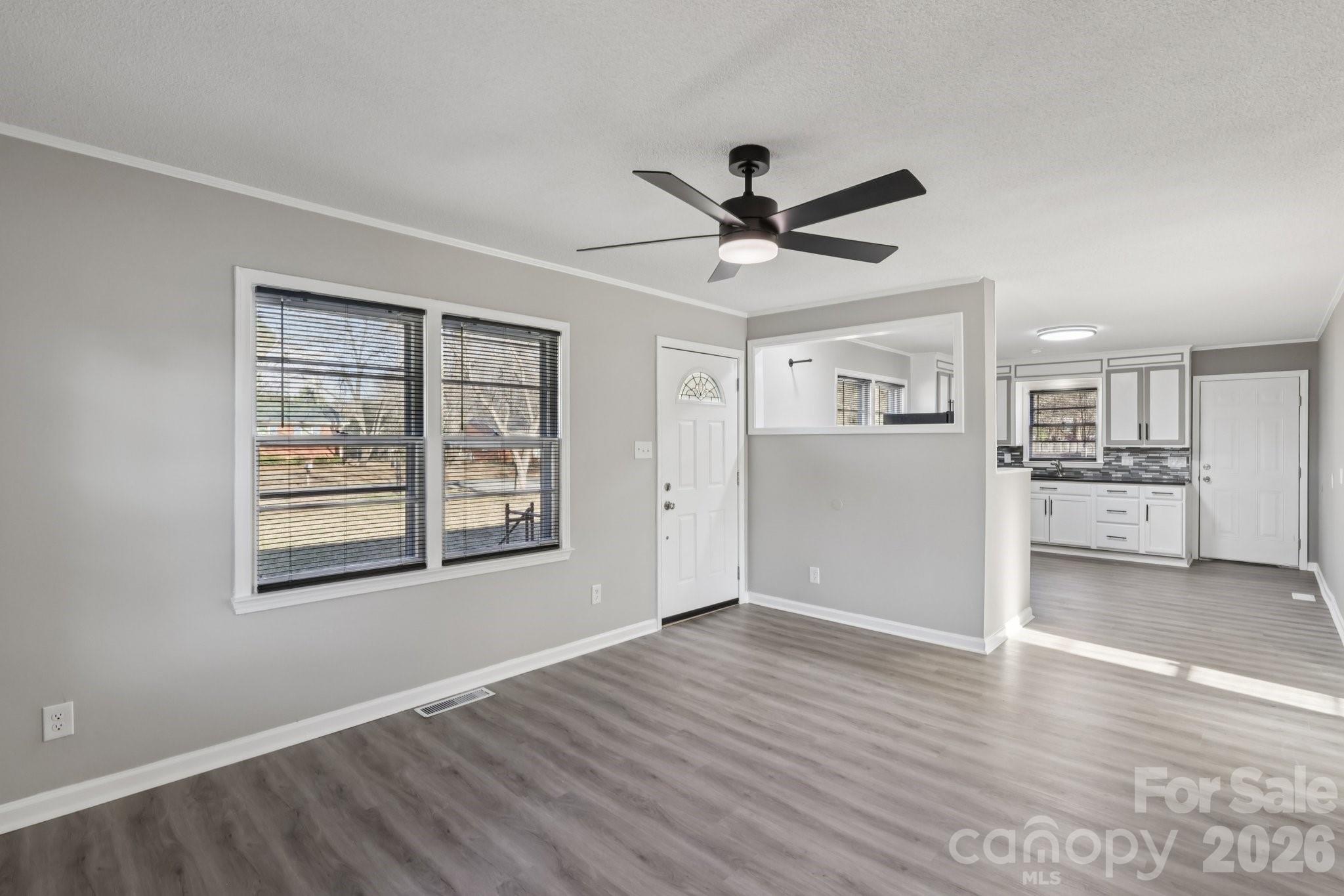 3207 Valley Dale Road Monroe, NC 28110 - Photo 5 of 30 a view of a big room with wooden floor and windows