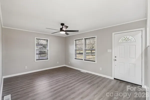 wooden floor in an empty room with a window