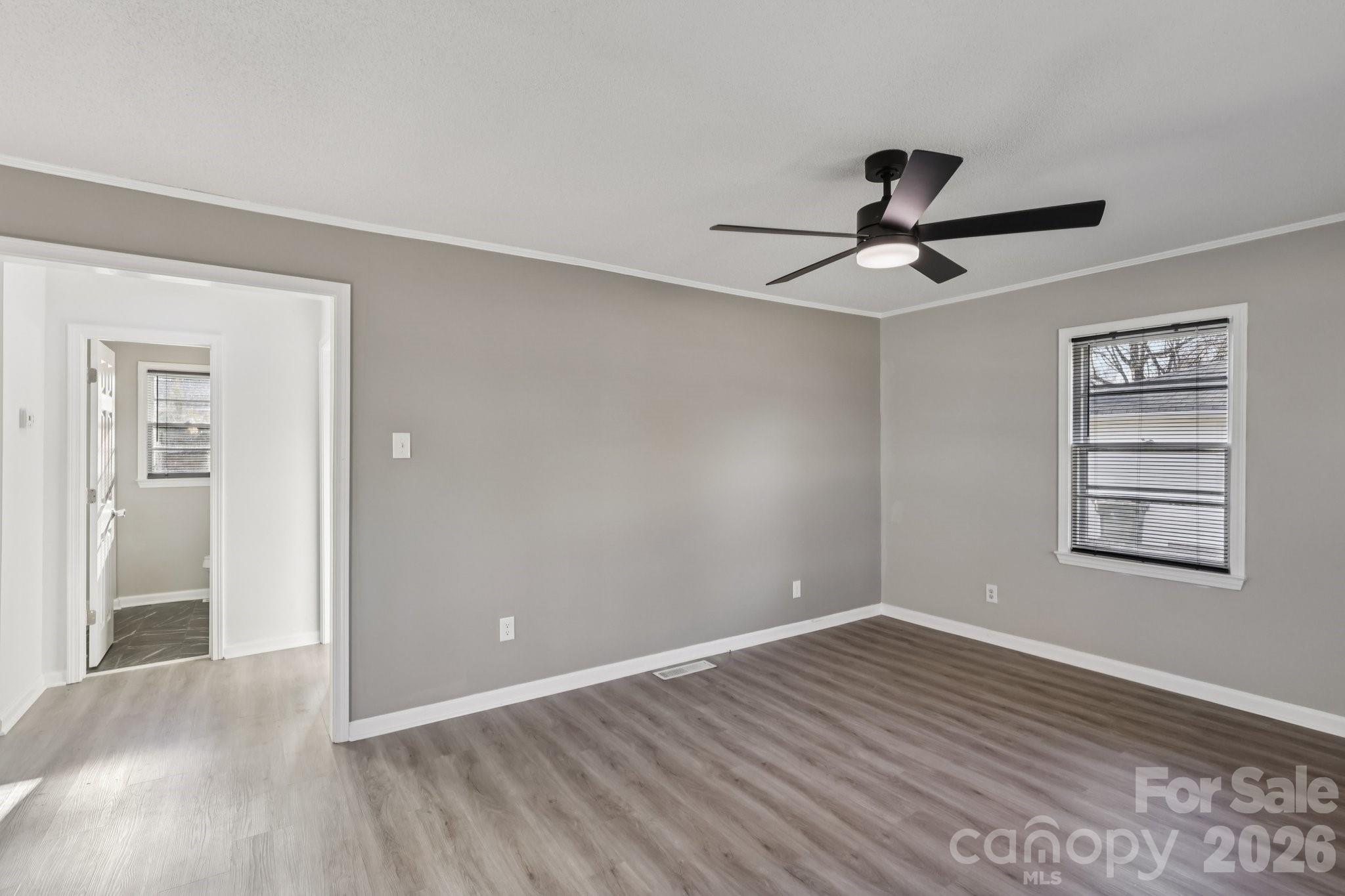 3207 Valley Dale Road Monroe, NC 28110 - Photo 8 of 30 a view of empty room with wooden floor and fan
