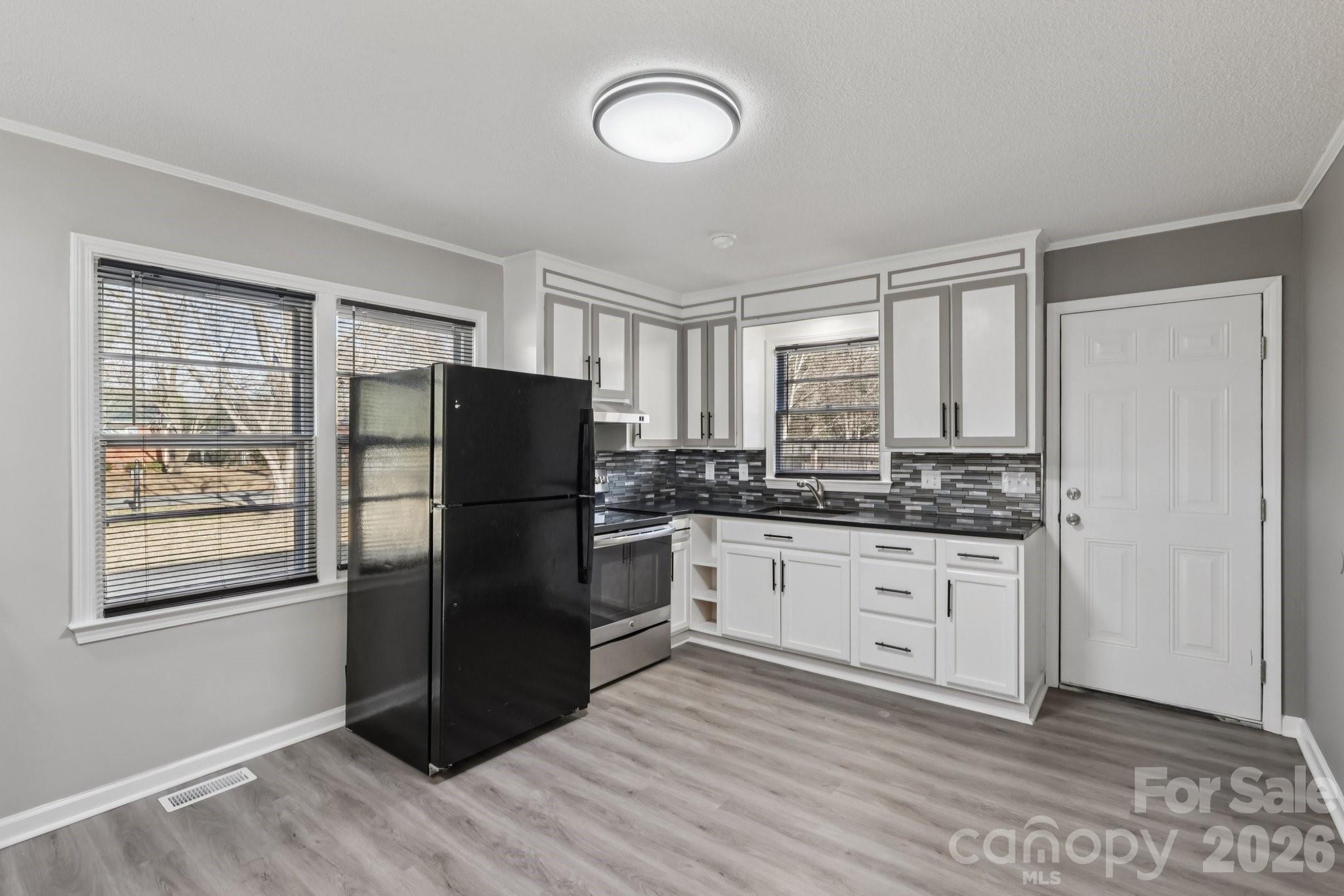 3207 Valley Dale Road Monroe, NC 28110 - Photo 9 of 30 a kitchen with granite countertop a refrigerator stove top oven and sink