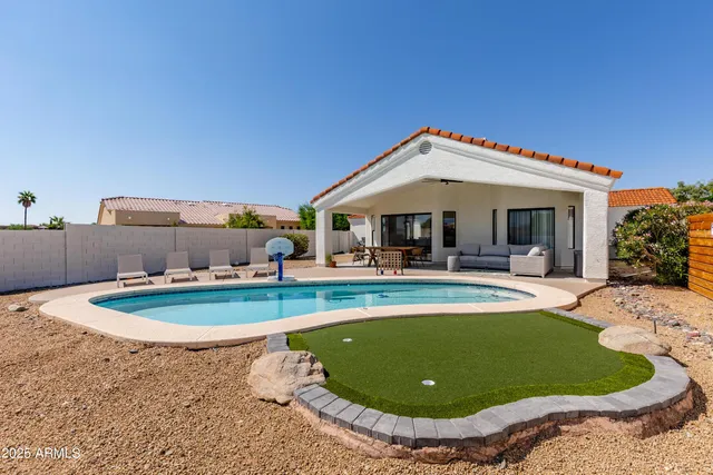 a view of a swimming pool with outdoor seating