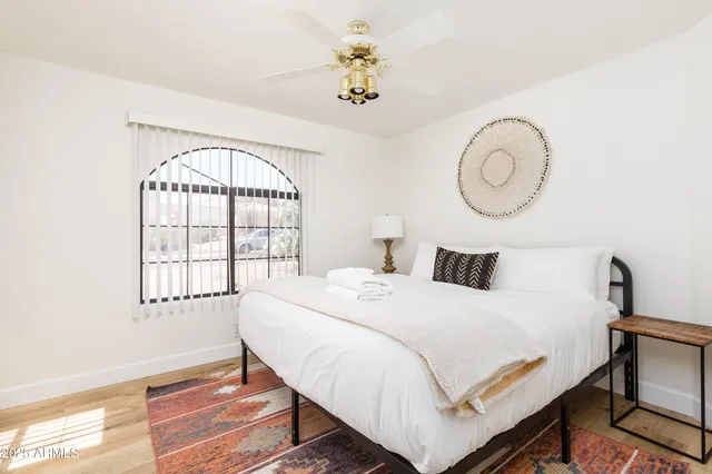 a bedroom with a bed and a window