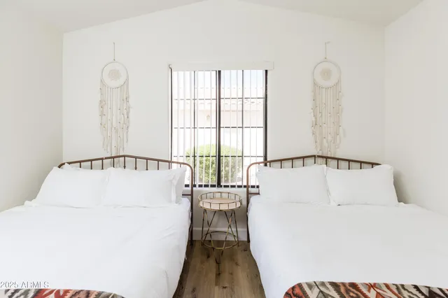 a living room with a white bed furniture and a window