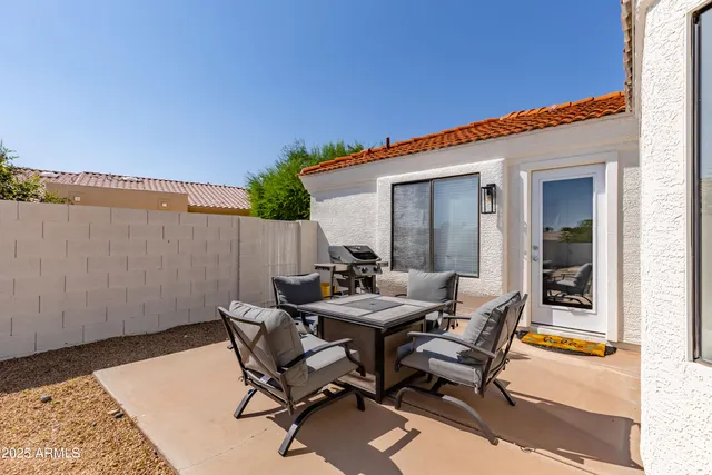 a view of a patio with table and chairs and potted plants