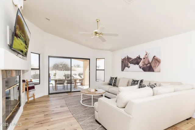 a living room with furniture and flat screen tv