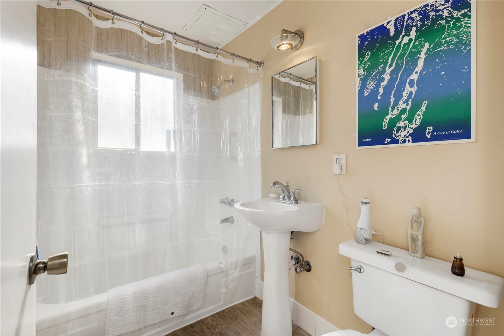 93 East Boston Street Seattle, WA 98102 - Photo 12 of 12 a bathroom with a sink a mirror a window and a shower
