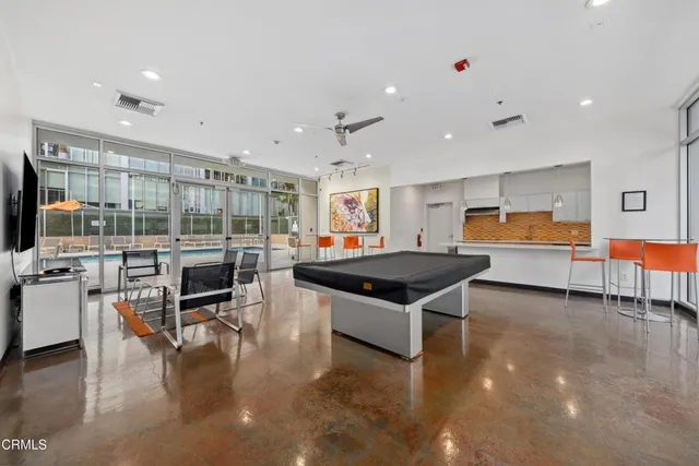 a kitchen with stainless steel appliances kitchen island granite countertop a stove and a sink