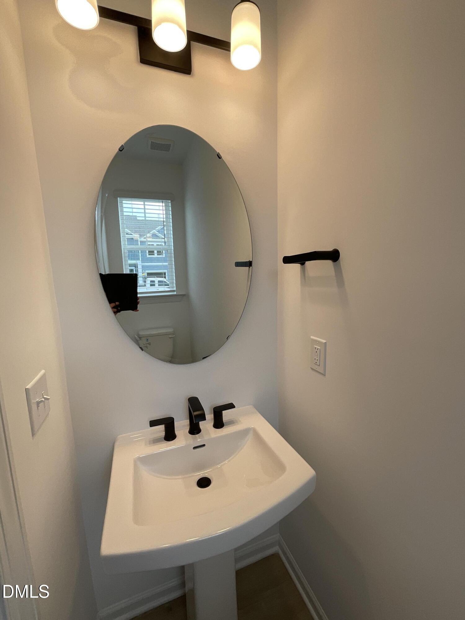 8712 Wardle Court Wake Forest, NC 27587 - Photo 14 of 33 a bathroom with a sink and a mirror