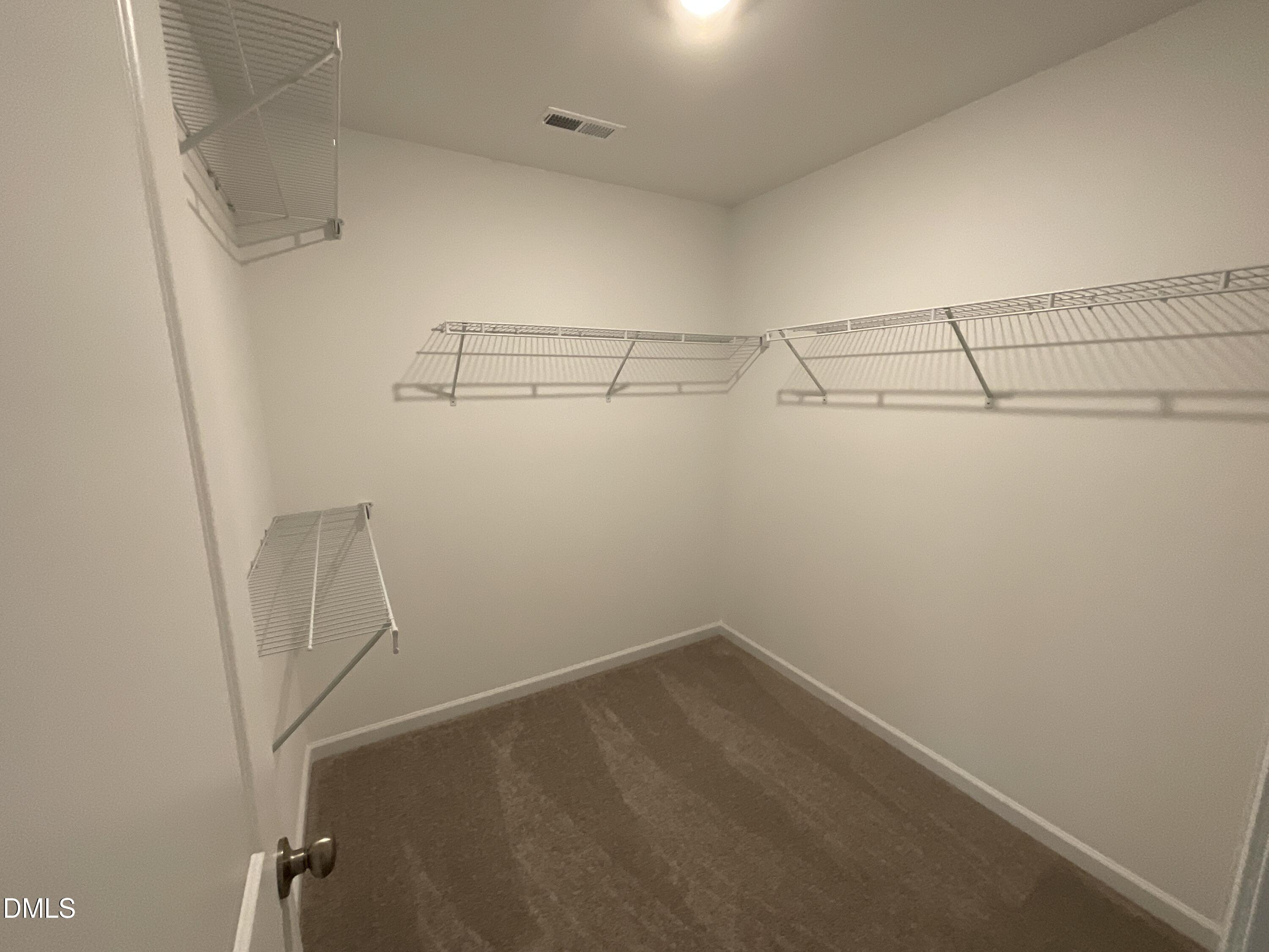 8712 Wardle Court Wake Forest, NC 27587 - Photo 15 of 33 a view of a room with racks on the wall